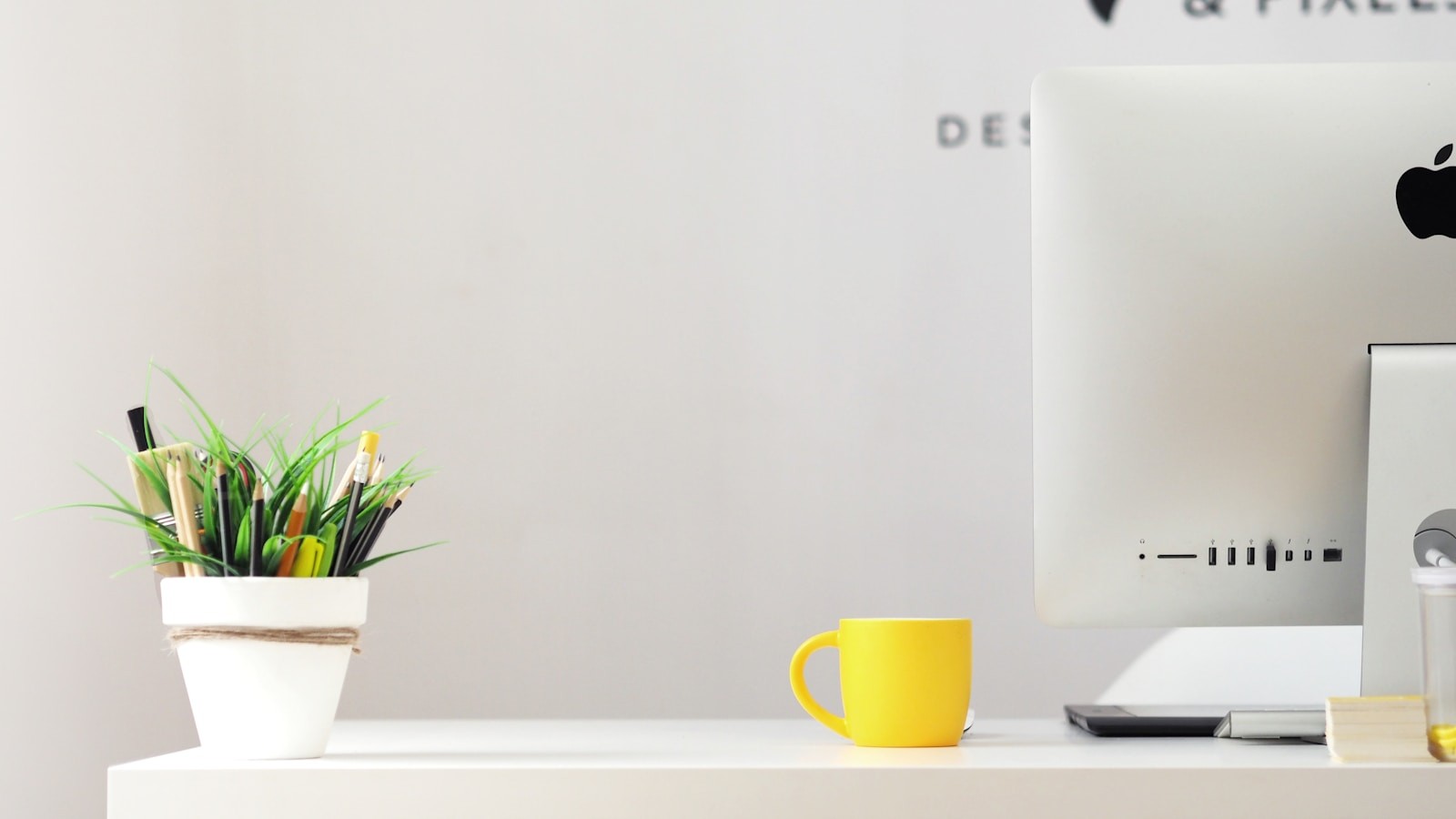 Photo by Georgie Cobbs yellow ceramic mug beside gray aluminum iMac