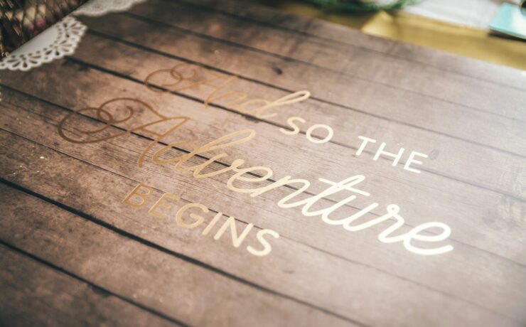 a wooden sign that says, so the adventure begins