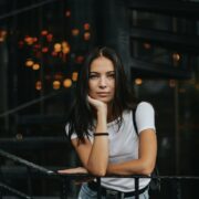 woman leaning on black handrail