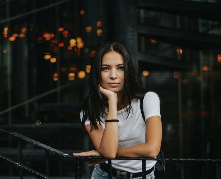 woman leaning on black handrail
