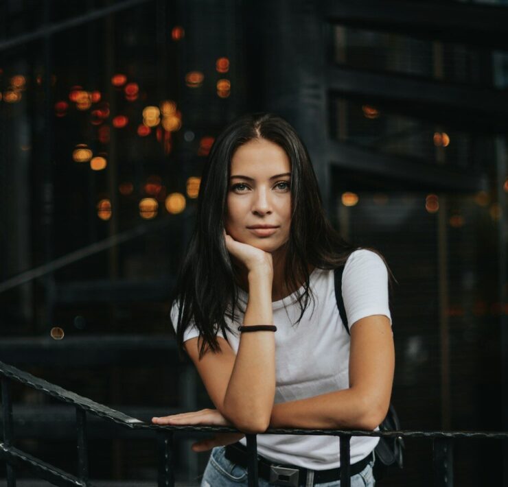 woman leaning on black handrail